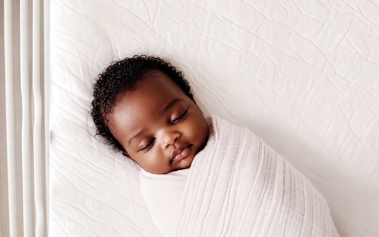 A peaceful sleeping newborn resting in a bright crib